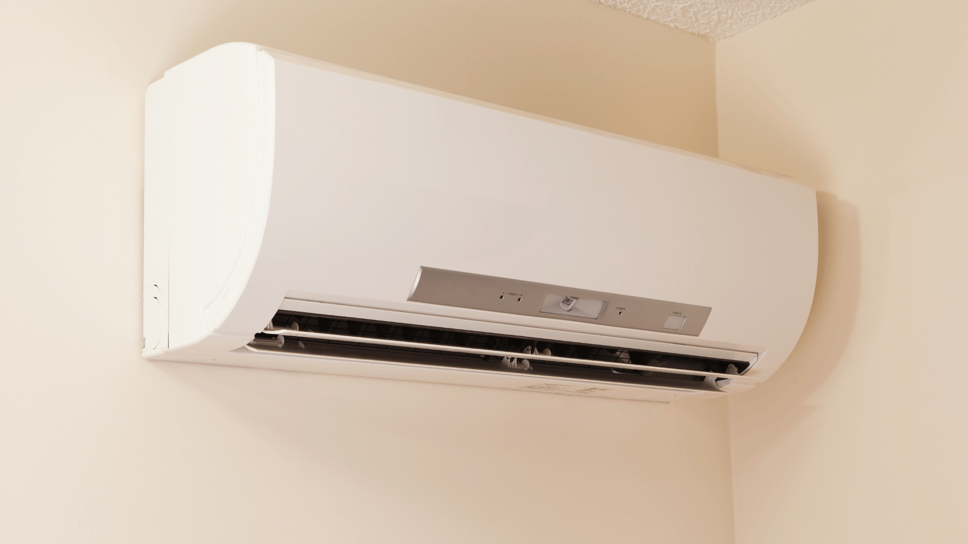 White ductless minisplit indoor unit mounted on a wall near the ceiling